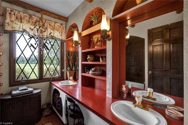 bathroom with tile patterned flooring and dual bowl vanity