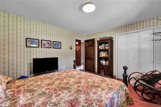 carpeted bedroom with a closet and a textured ceiling