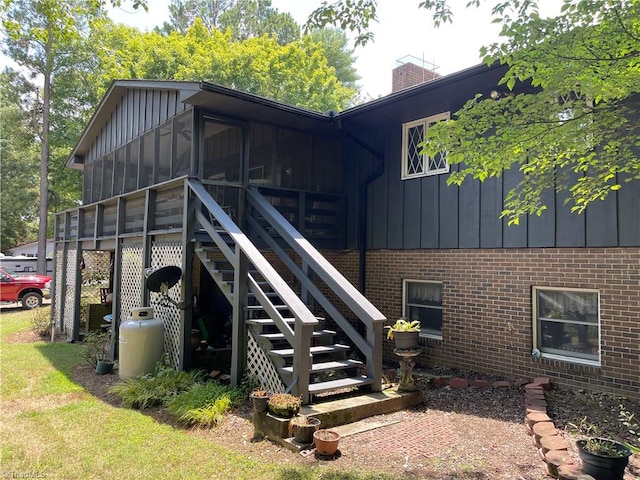 back of house featuring a sunroom