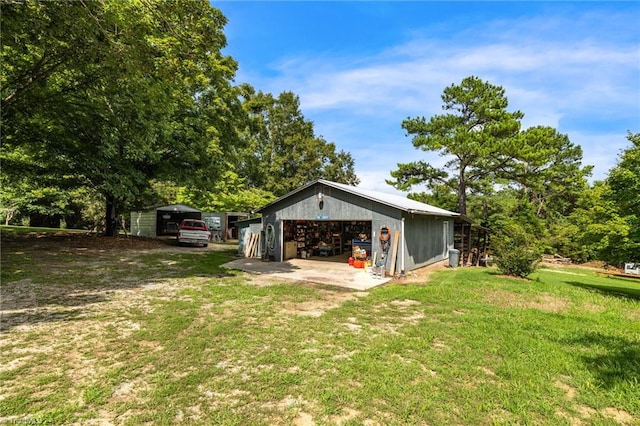 exterior space with a garage and an outbuilding