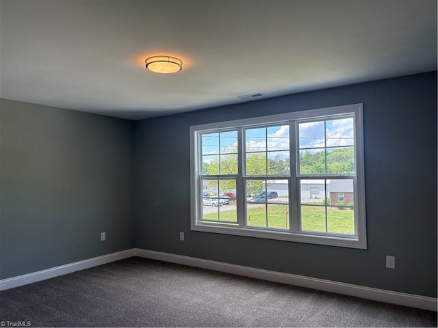 7376 Ridge Rd, Winston-Salem, NC 27107 - unfurnished room with baseboards, a healthy amount of sunlight, dark colored carpet, and visible vents