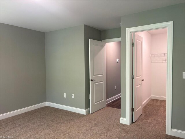 7376 Ridge Rd, Winston-Salem, NC 27107 - unfurnished bedroom featuring a spacious closet, carpet flooring, and baseboards
