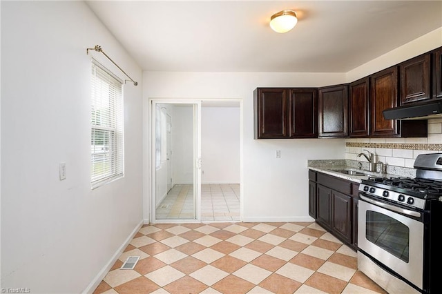 1309 Jackson St, Burlington, NC 27217 - kitchen featuring gas stove, a sink, extractor fan, and baseboards