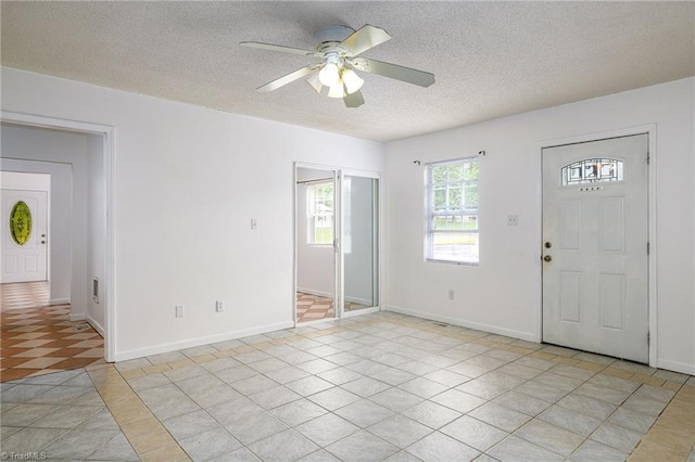 1309 Jackson St, Burlington, NC 27217 - entryway featuring a ceiling fan, a textured ceiling, baseboards, and light tile patterned floors