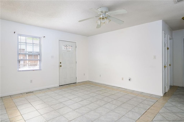 1309 Jackson St, Burlington, NC 27217 - spare room with ceiling fan, a textured ceiling, baseboards, and light tile patterned flooring