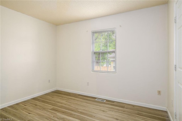 1309 Jackson St, Burlington, NC 27217 - spare room with light wood-type flooring and baseboards