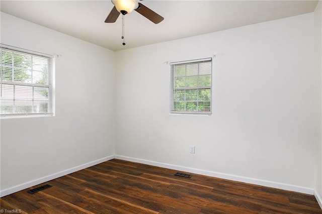 1309 Jackson St, Burlington, NC 27217 - empty room featuring healthy amount of natural light, baseboards, dark wood-style floors, and ceiling fan