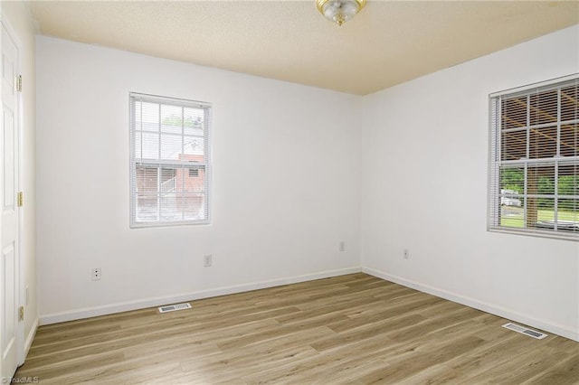1309 Jackson St, Burlington, NC 27217 - empty room featuring light wood-style floors and baseboards