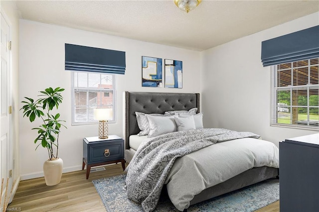 1309 Jackson St, Burlington, NC 27217 - bedroom with light wood-style flooring, multiple windows, and baseboards