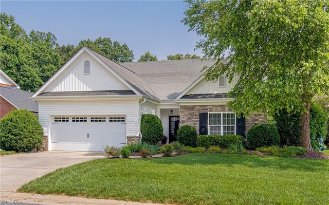 125 Valencia Ln, Winston-Salem, NC 27106 - craftsman-style home featuring board and batten siding, a garage, driveway, stone siding, and a front lawn
