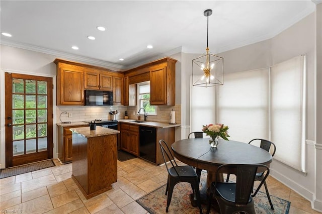 641 Doe Run Dr, Kernersville, NC 27284 - kitchen featuring black appliances, a sink, crown molding, tasteful backsplash, and a center island