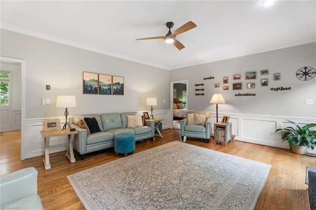 641 Doe Run Dr, Kernersville, NC 27284 - living area featuring ceiling fan, ornamental molding, light wood-style floors, a wainscoted wall, and a decorative wall