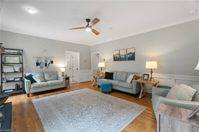 641 Doe Run Dr, Kernersville, NC 27284 - living room with a ceiling fan, crown molding, wainscoting, wood finished floors, and a decorative wall