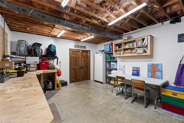 641 Doe Run Dr, Kernersville, NC 27284 - basement featuring freestanding refrigerator and a workshop area