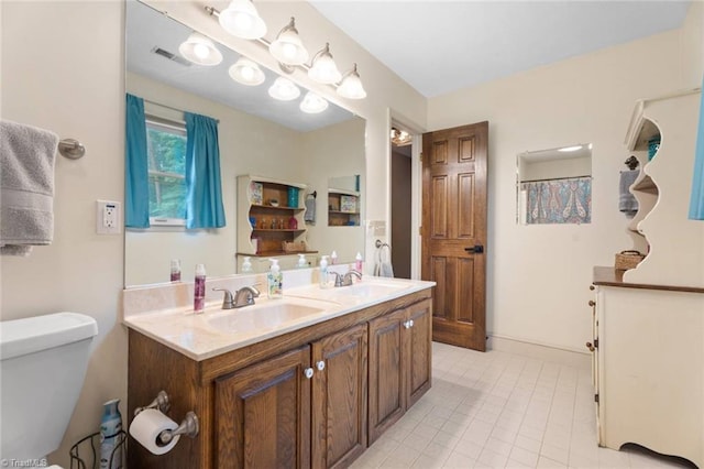 641 Doe Run Dr, Kernersville, NC 27284 - bathroom featuring toilet, double vanity, and tile patterned flooring