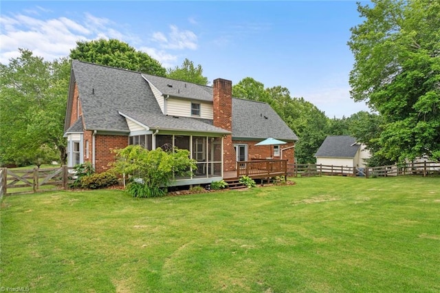 641 Doe Run Dr, Kernersville, NC 27284 - back of house featuring a sunroom, a chimney, brick siding, a deck, and roof with shingles