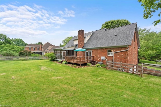 641 Doe Run Dr, Kernersville, NC 27284 - back of property featuring a sunroom, brick siding, a deck, a chimney, and roof with shingles