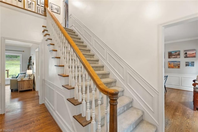 641 Doe Run Dr, Kernersville, NC 27284 - stairs with a decorative wall, wood finished floors, crown molding, and a wainscoted wall