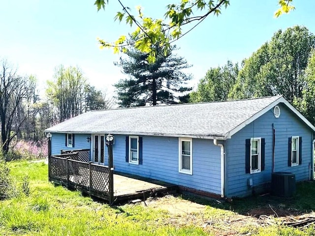 rear view of house featuring a deck and cooling unit