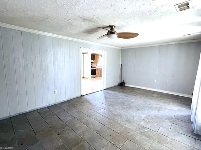 spare room featuring ceiling fan, a textured ceiling, and ornamental molding