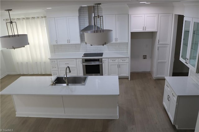 6215 Glen Way Dr, Winston-Salem, NC 27107 - kitchen featuring oven, cooktop, white cabinets, wood finished floors, and decorative backsplash