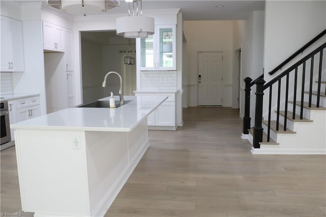 6215 Glen Way Dr, Winston-Salem, NC 27107 - kitchen featuring decorative backsplash, white cabinetry, and light wood-style flooring