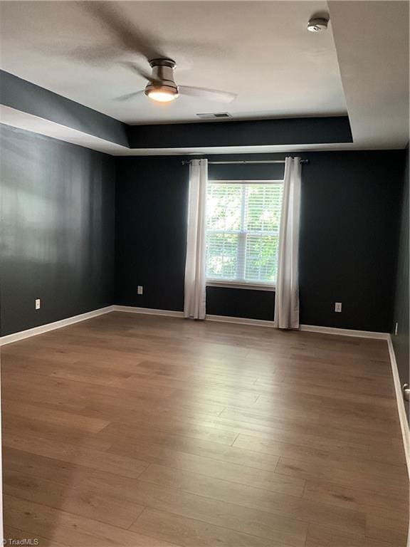 6215 Glen Way Dr, Winston-Salem, NC 27107 - unfurnished room featuring a smoke detector, wood finished floors, ceiling fan, and a tray ceiling