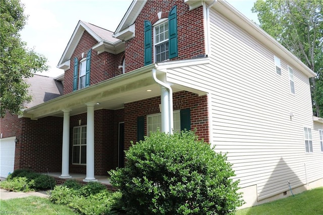 6215 Glen Way Dr, Winston-Salem, NC 27107 - view of home's exterior with a porch, a garage, and brick siding