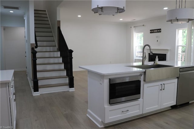 6215 Glen Way Dr, Winston-Salem, NC 27107 - kitchen with stainless steel appliances, light countertops, light wood finished floors, and recessed lighting