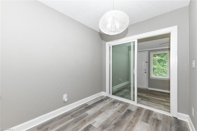 311 Salisbury St Unit 50, Kernersville, NC 27284 - spare room featuring a chandelier, wood finished floors, and baseboards