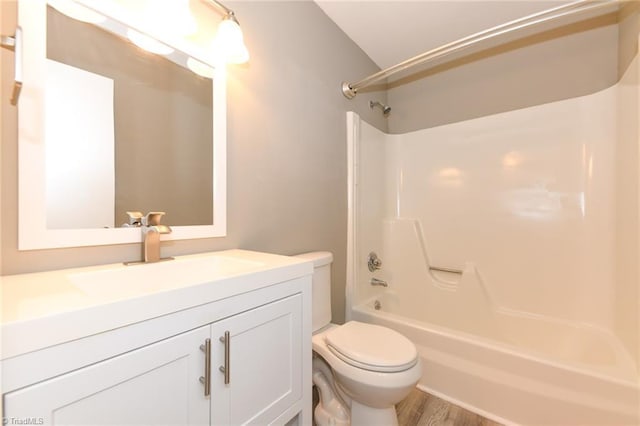 311 Salisbury St Unit 50, Kernersville, NC 27284 - bathroom featuring toilet, vanity, shower / bathtub combination, wood finished floors, and lofted ceiling
