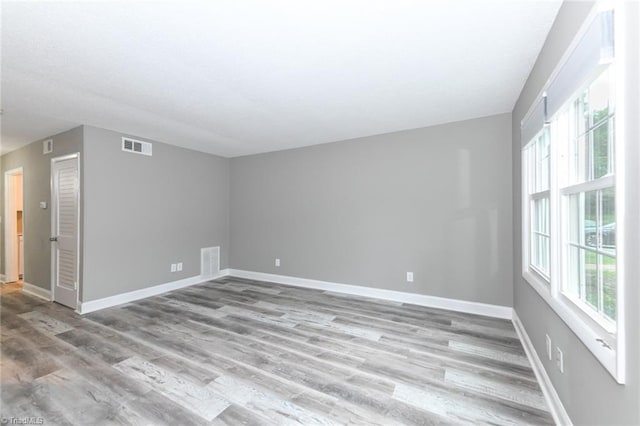 311 Salisbury St Unit 50, Kernersville, NC 27284 - empty room featuring healthy amount of natural light, wood finished floors, and baseboards