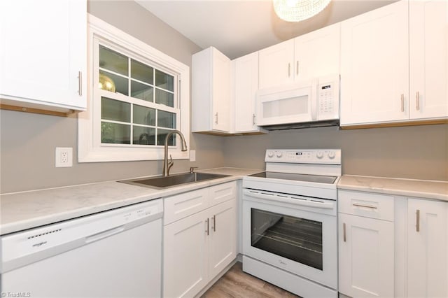 311 Salisbury St Unit 50, Kernersville, NC 27284 - kitchen with white appliances, a sink, white cabinetry, and light wood-type flooring