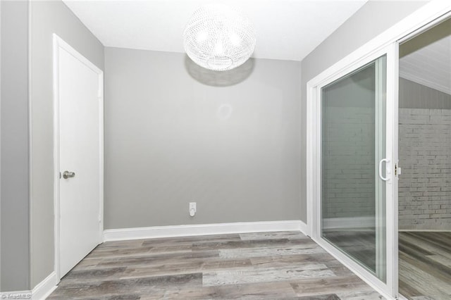 311 Salisbury St Unit 50, Kernersville, NC 27284 - empty room featuring wood finished floors, baseboards, and vaulted ceiling