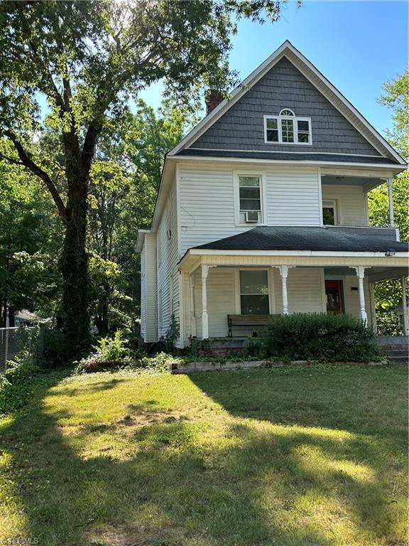 view of front of house with a porch and a front yard