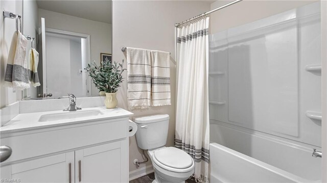 full bathroom with shower / bath combination with curtain, vanity, and toilet
