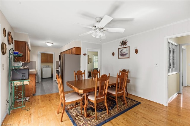 213 Timmys Ln, King, NC 27021 - dining space featuring washer / dryer, a ceiling fan, light wood finished floors, and crown molding