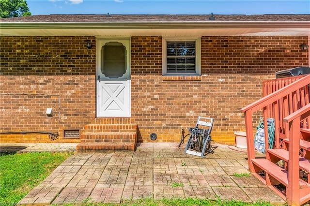 213 Timmys Ln, King, NC 27021 - property entrance featuring brick siding, a patio area, and crawl space