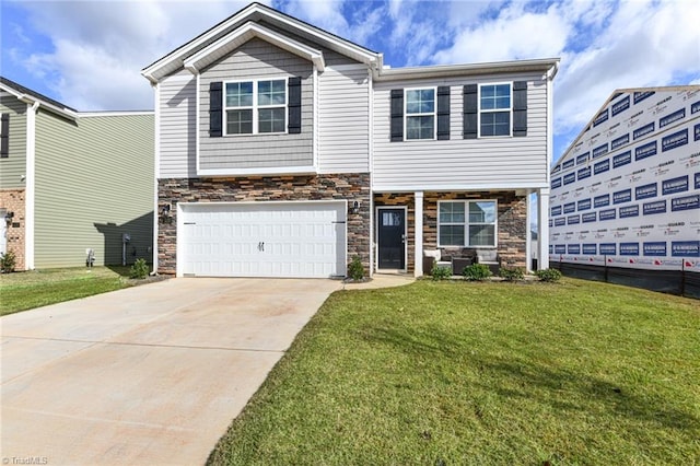 view of front of home with a garage and a front lawn