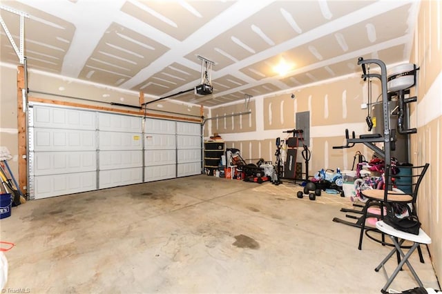 garage featuring electric panel and a garage door opener