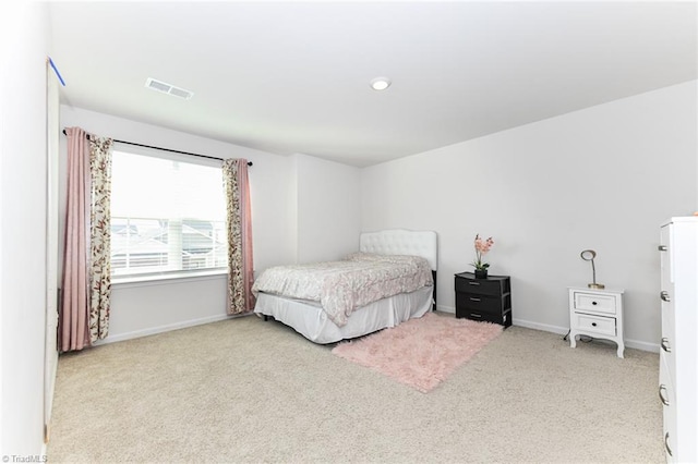 bedroom featuring light carpet