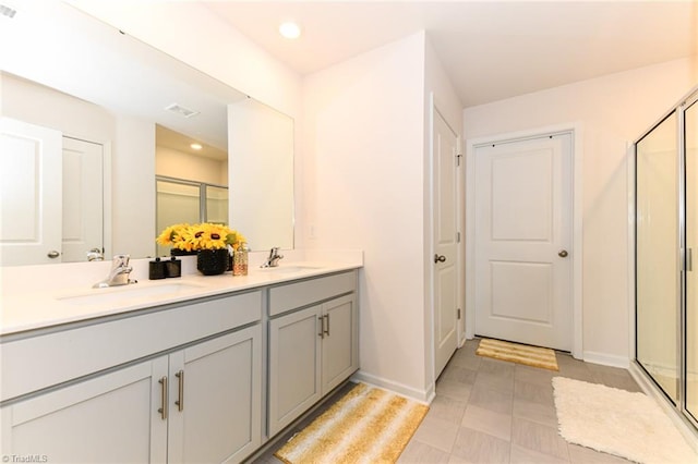 bathroom with vanity and a shower with shower door