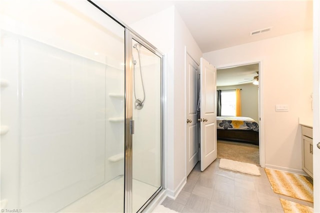 bathroom featuring vanity, ceiling fan, and a shower with shower door