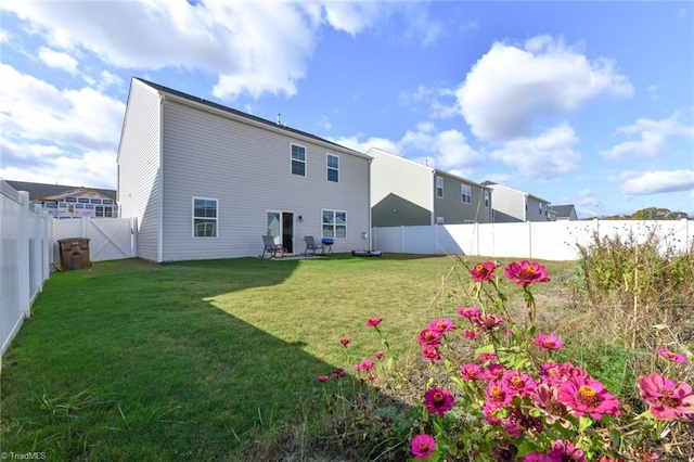 rear view of property with a lawn