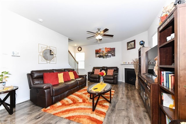 living room with hardwood / wood-style floors and ceiling fan