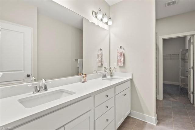 full bathroom featuring double vanity, visible vents, tile patterned flooring, and a sink