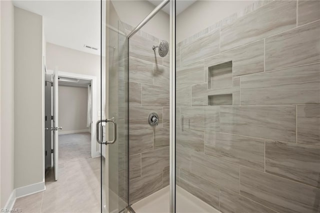 full bathroom featuring baseboards, visible vents, and a shower stall