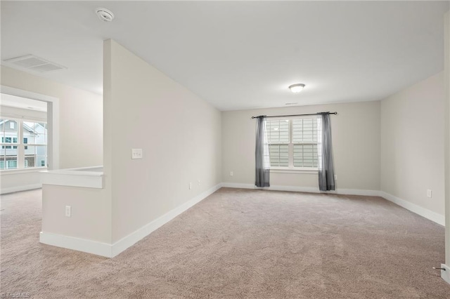 unfurnished room featuring carpet, a healthy amount of sunlight, and baseboards
