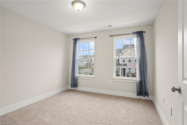 unfurnished room featuring baseboards and carpet