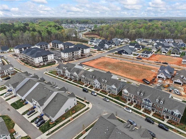 birds eye view of property featuring a wooded view and a residential view